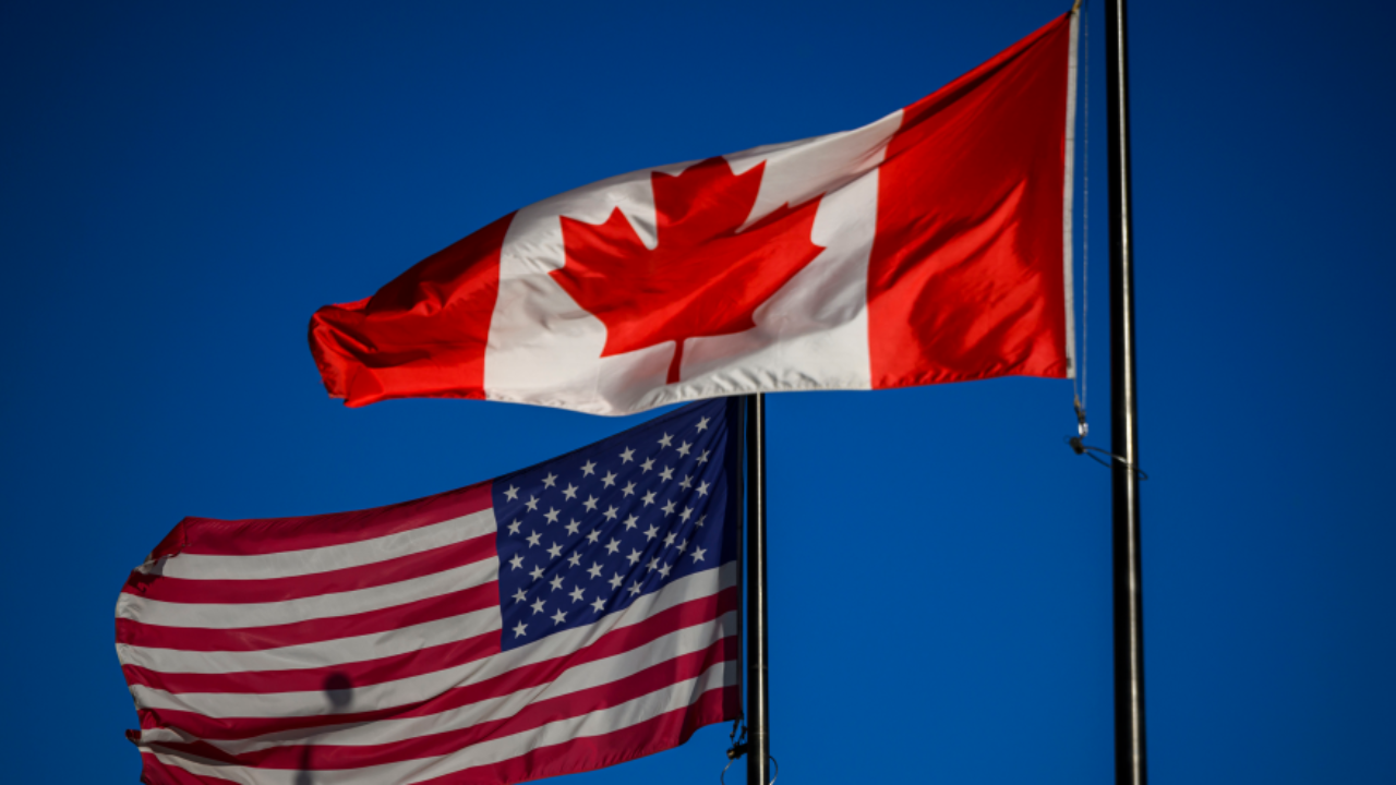 Canada and US flags - Justin TangThe Canadian Press via AP