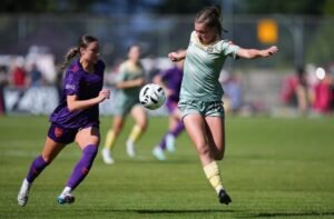 Calgary Wild's Danielle Steer, left, and Vancouver Rise's Chloe Taylor vie for the ball during the first half of an NSL soccer match, in Burnaby, B.C. -THE CANADIAN PRESS/Darryl Dyck